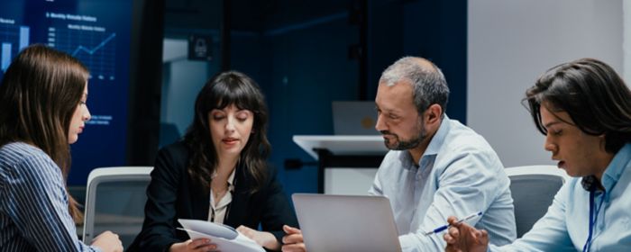People are sitting around the table during the meeting